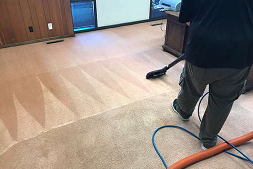 man vacuuming and cleaning carpet