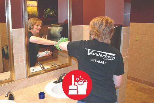 Sherry detail cleaning a large restroom for a janitorial customer of vanderberg clean.